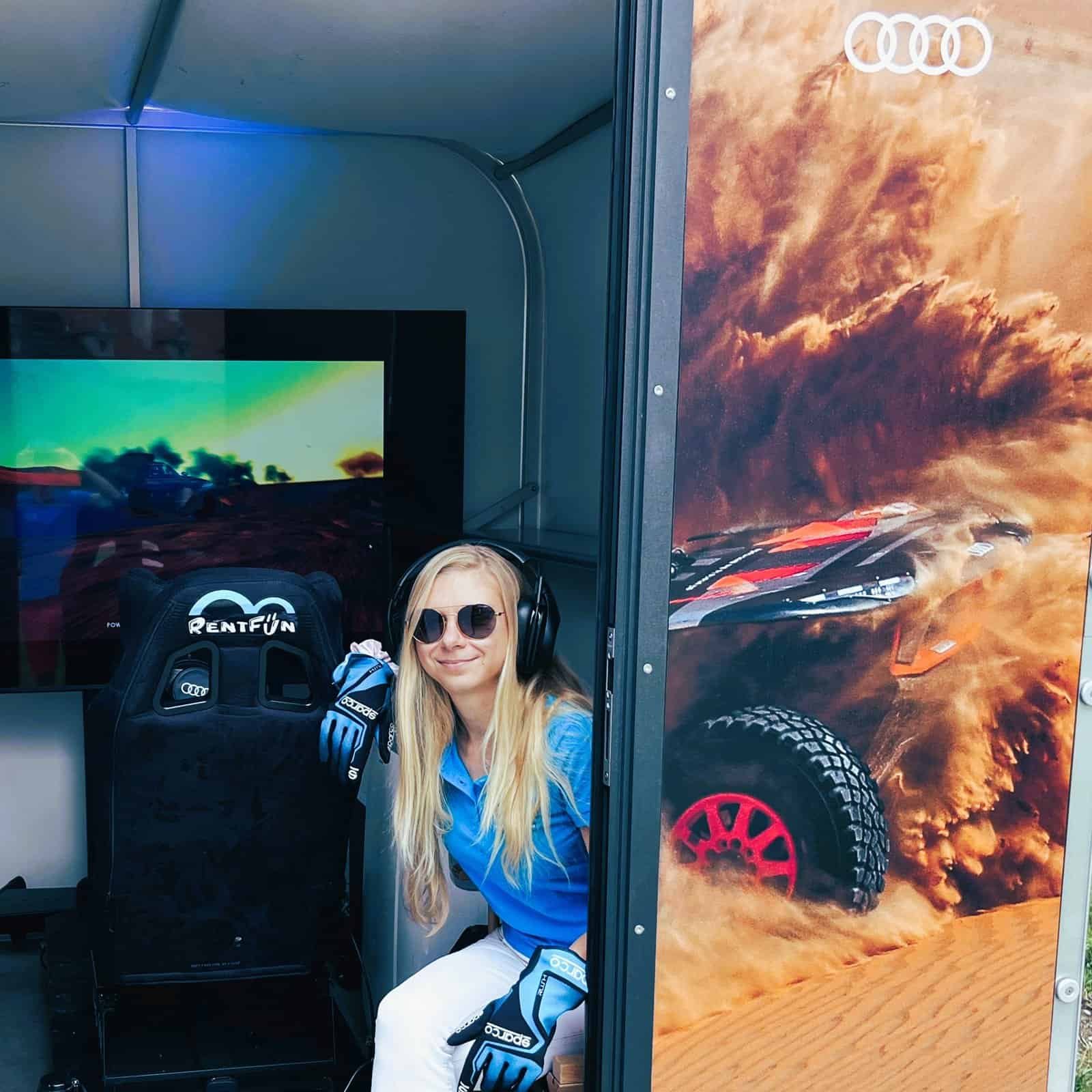 Happy girl with Audi Dakar mobile racing simulator hire. Audi Audi RS Q e-tron virtual racing simulator with professional components in a Saudi Arabia.
