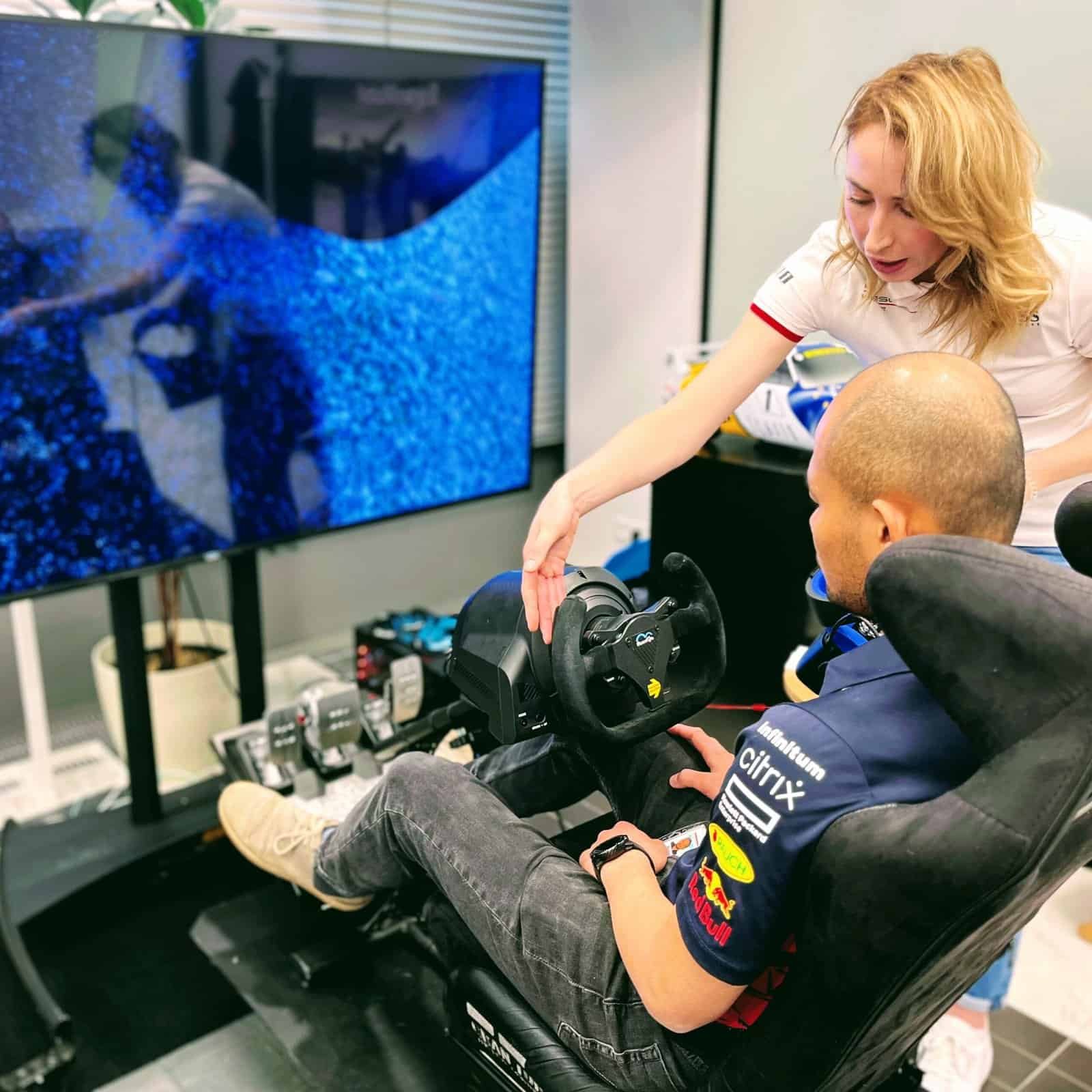 RoarFun team providing support on professional porsche racing simulator at event venue in Prague, Czech Republic at the corporate office headquarters.