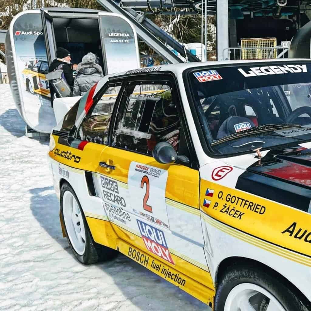 Audi rally simulator next to a real Audi S1 E2 rally car. Mobile simulator hire on a snow in Berlin, Germany.