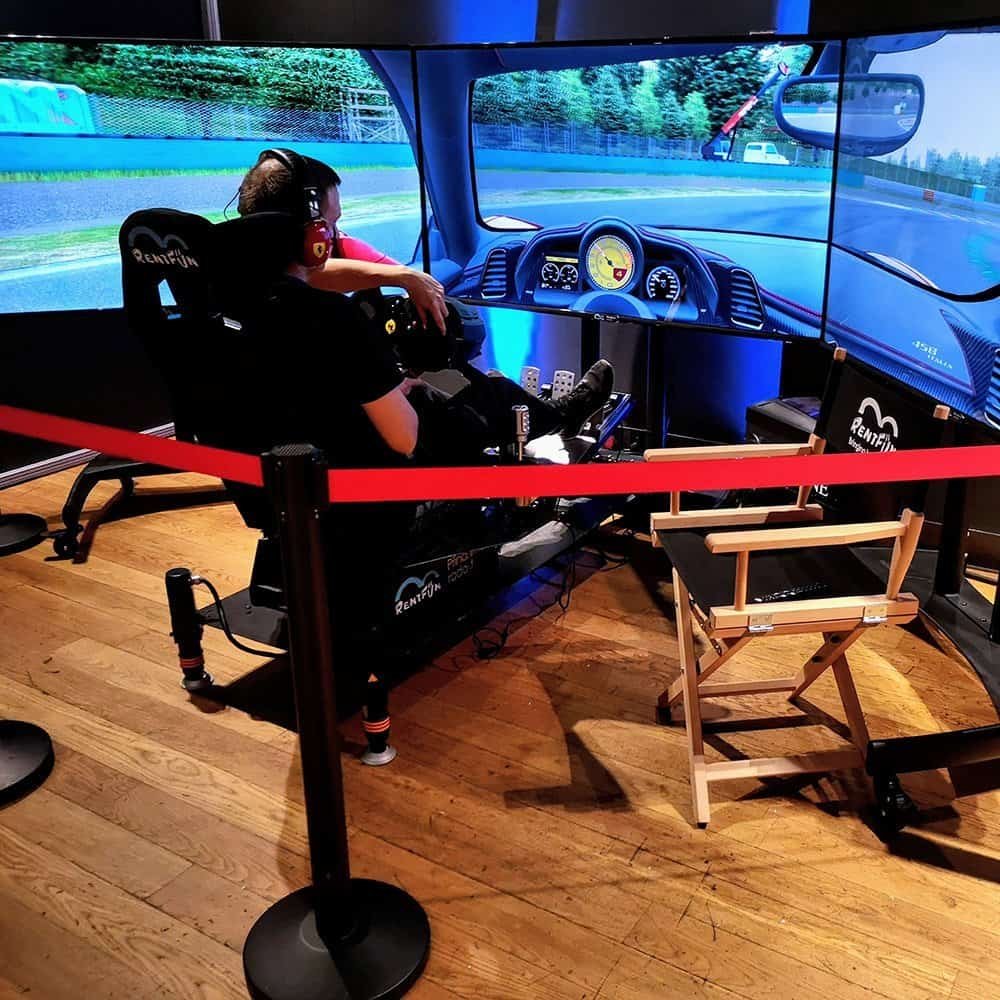 Professional Ferrari race simulation hire for company event in Bologna on a Monza virtual racing track in Italy. Branded racing simulator attracting attendees at a product launch event.