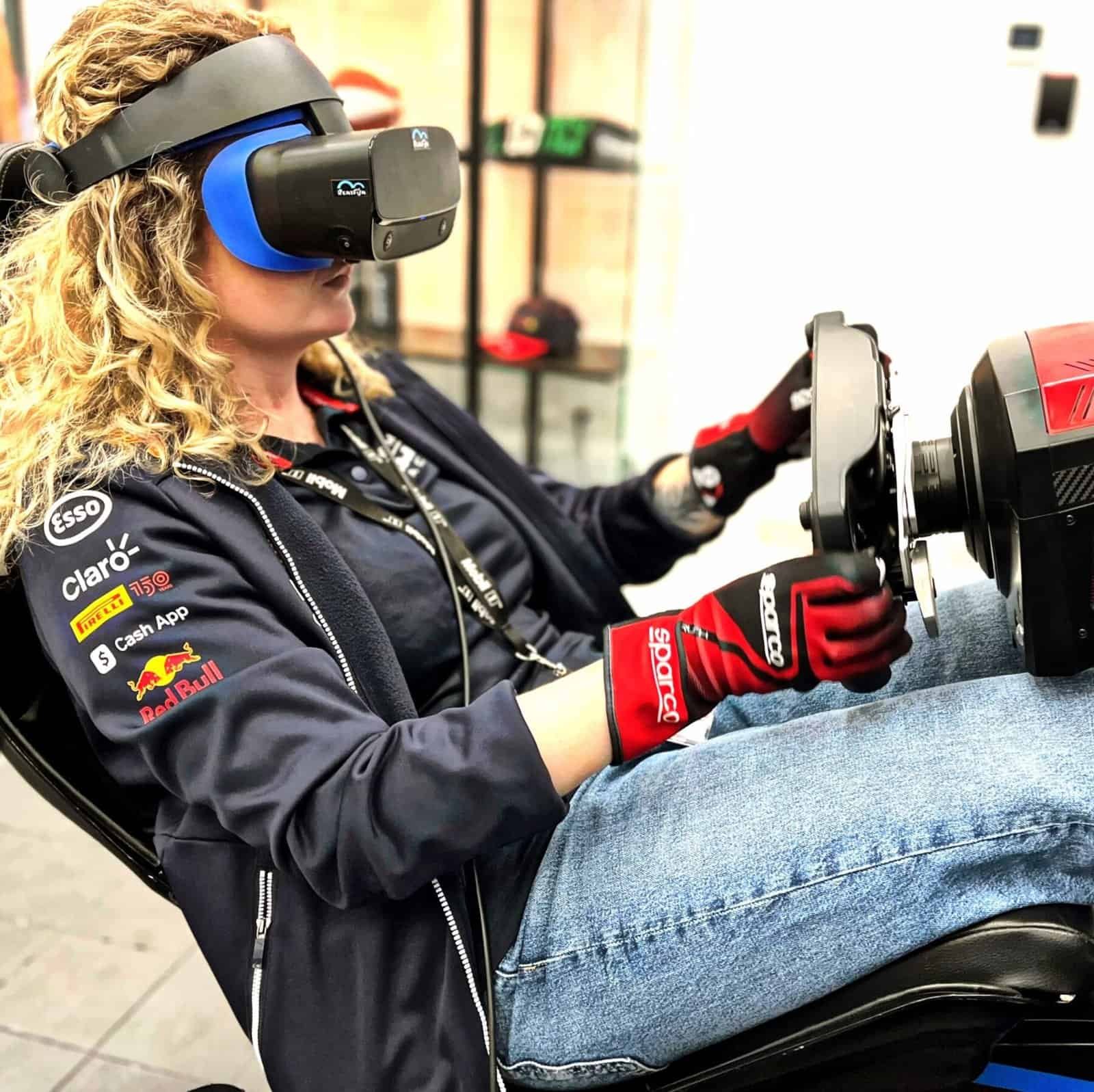 Women in virtual reality on the best vr racing motion simulator rented in London, UK.