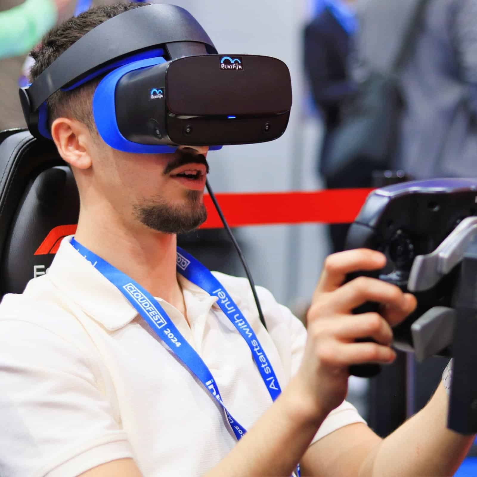 Man in a virtual reality headset driving a Formula car fast on Cloudfest.