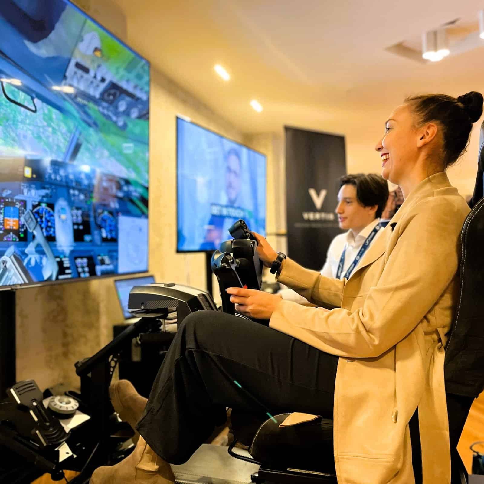 Happy lady with a flight simulator at the heathrow aviation carbon event.