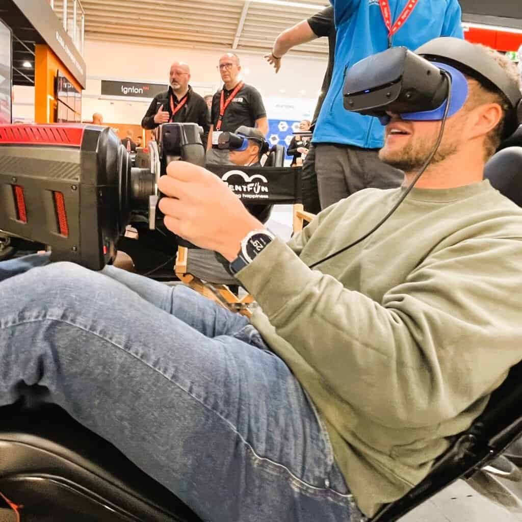 Happy person in VR enjoying motion F1 simulator.