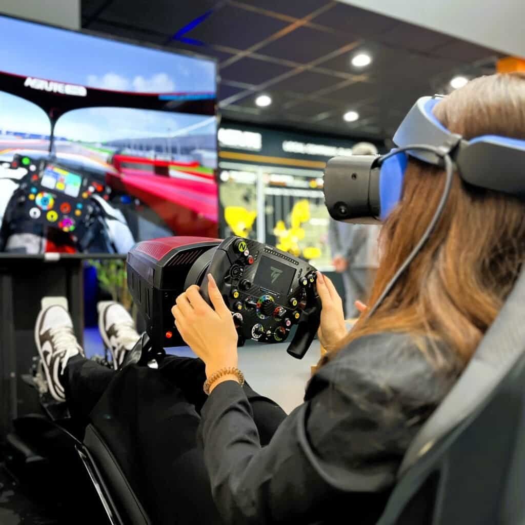 Nice lady in virtual reality with motion racing simulator rental in Munich.